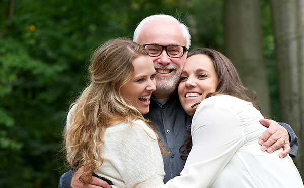 Father smiling with his daughters